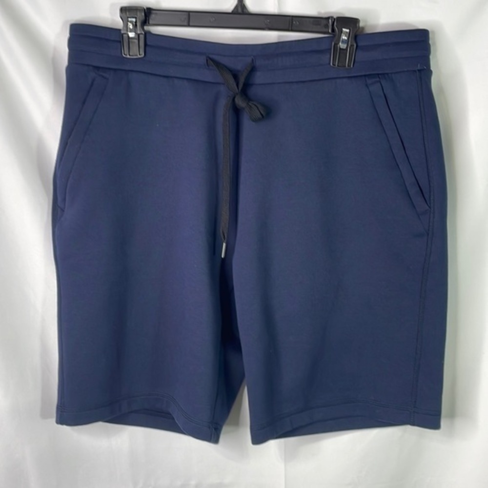 32°. Navy blue knit shorts.